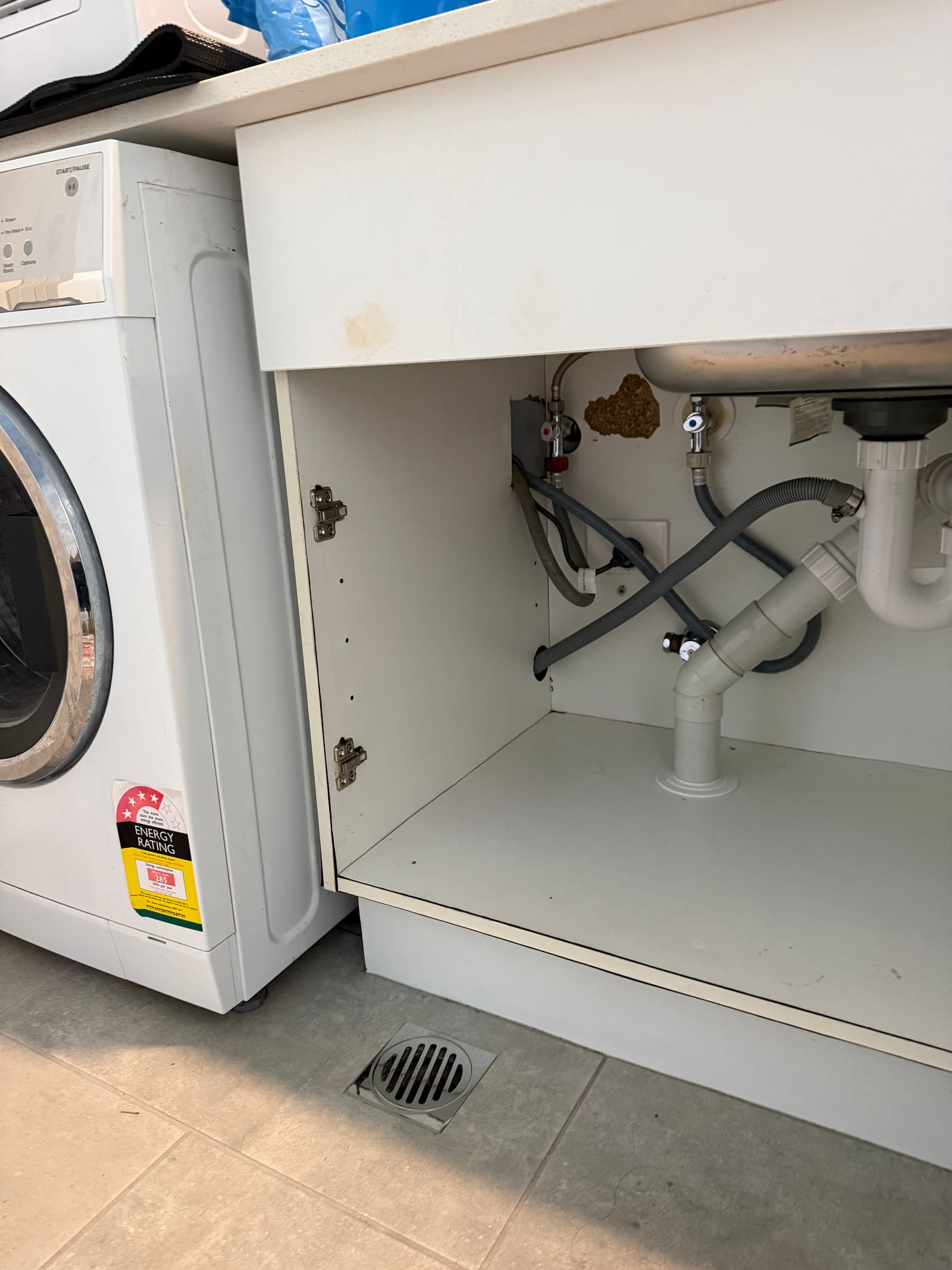 Water staining left behind on the laundry cabinet after the washing machine hose split in Balgowlah