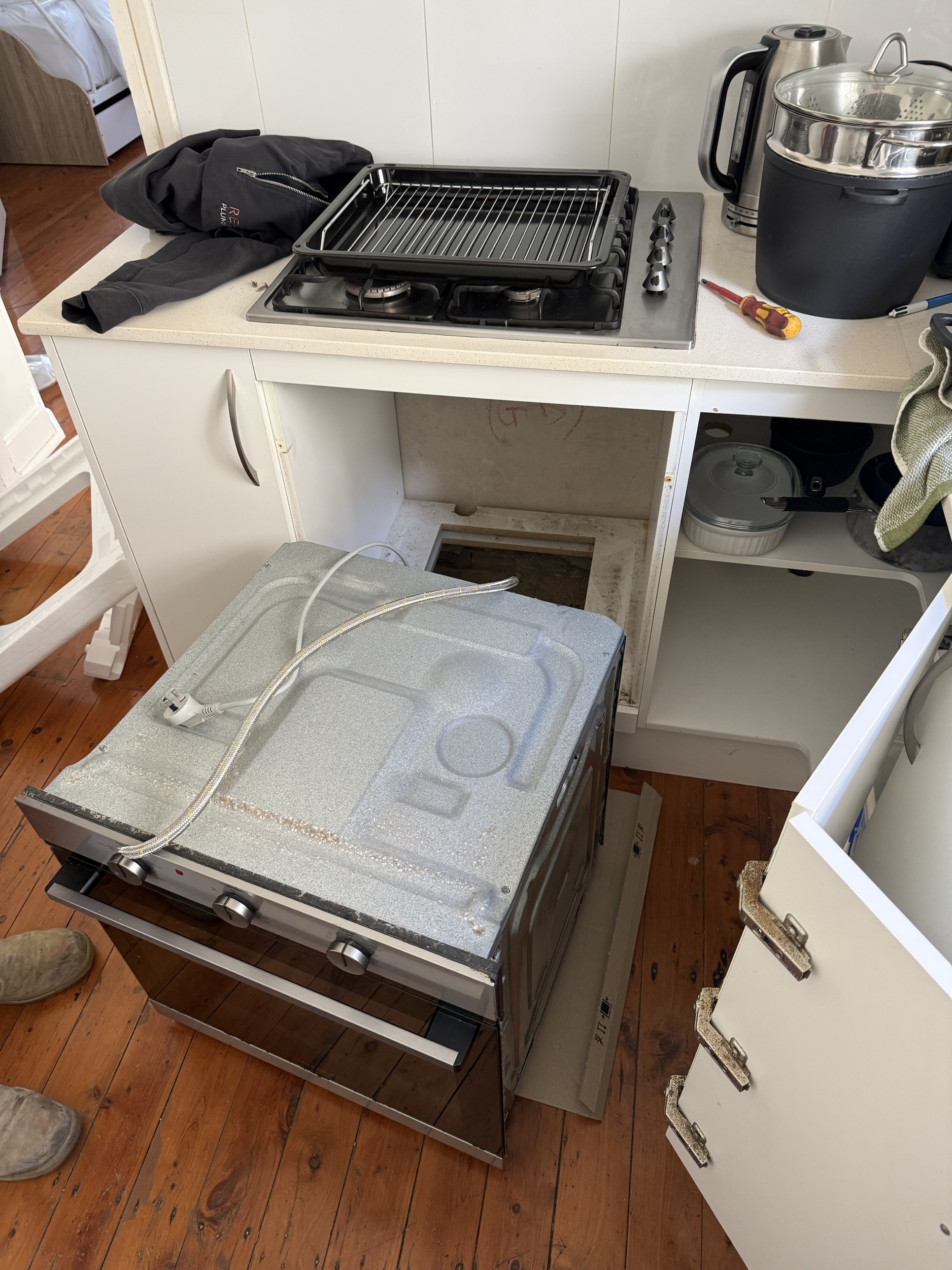 Old gas oven disconnected and pulled out from under the cooktop in Fairlight
