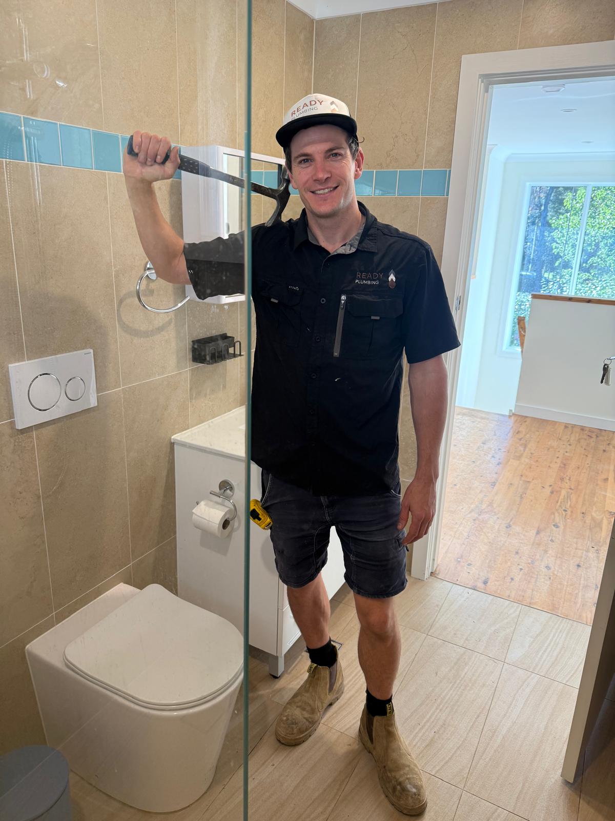 Ready Plumbing plumber in a completed bathroom renovation