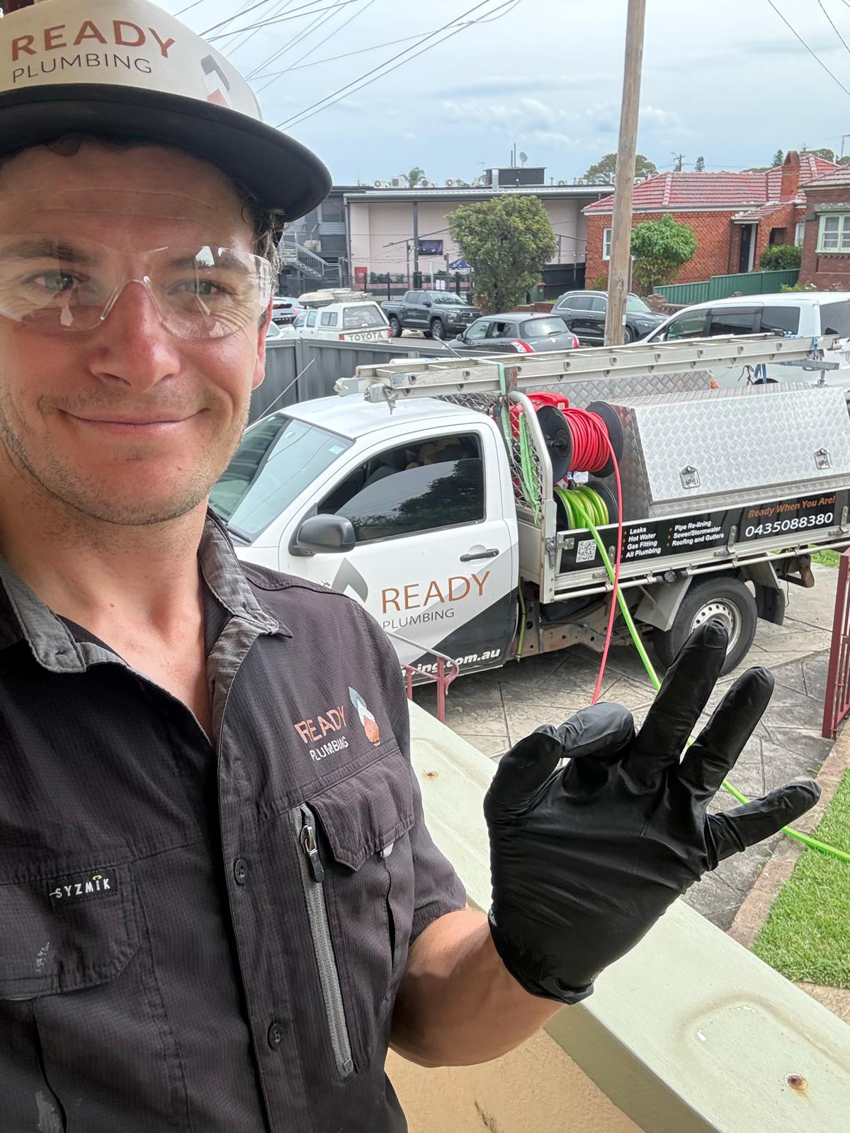 Ready Plumbing plumber with the high-pressure water jetter on the work ute